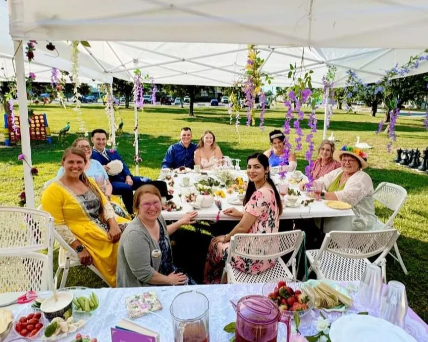 Attendees "spill the tea" at a Bridgerton-themed tea party